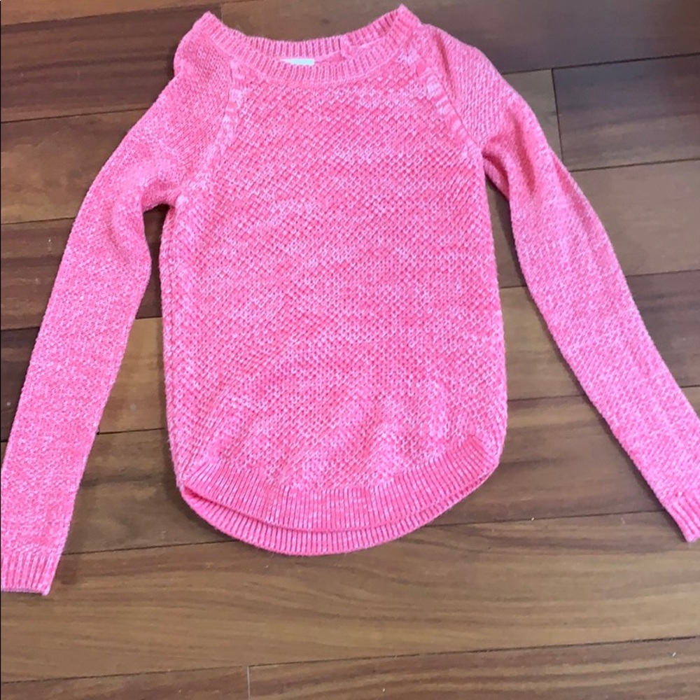 Pink knit pullover.